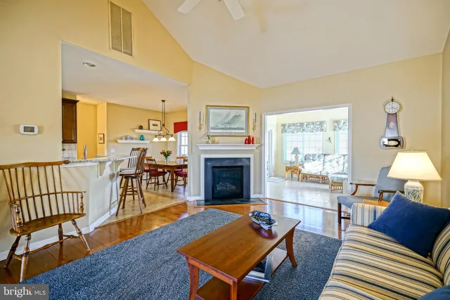 a living room with furniture a table and a fireplace