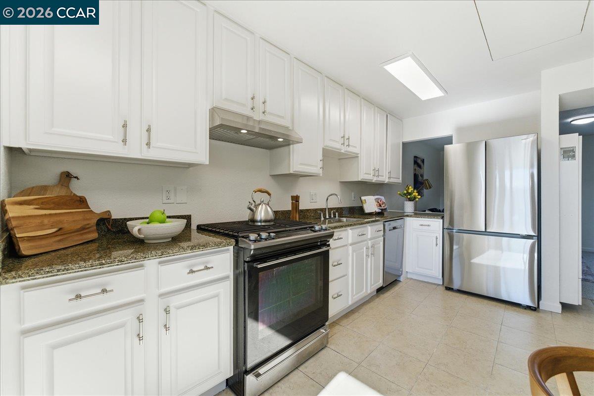 4740 Appian Way, Unit 9 El Sobrante, CA 94803 - Photo 11 of 23 a kitchen with stainless steel appliances granite countertop a refrigerator sink and stove