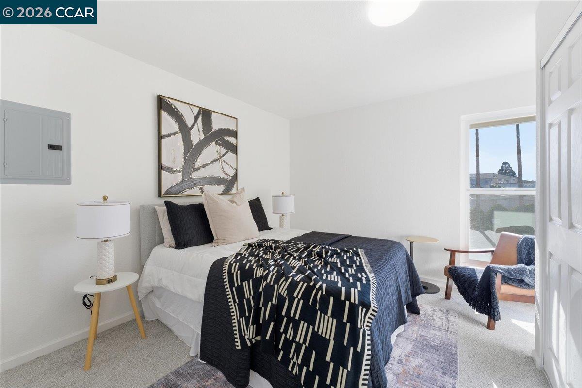 4740 Appian Way, Unit 9 El Sobrante, CA 94803 - Photo 14 of 23 a bedroom with a bed and a painting on the wall