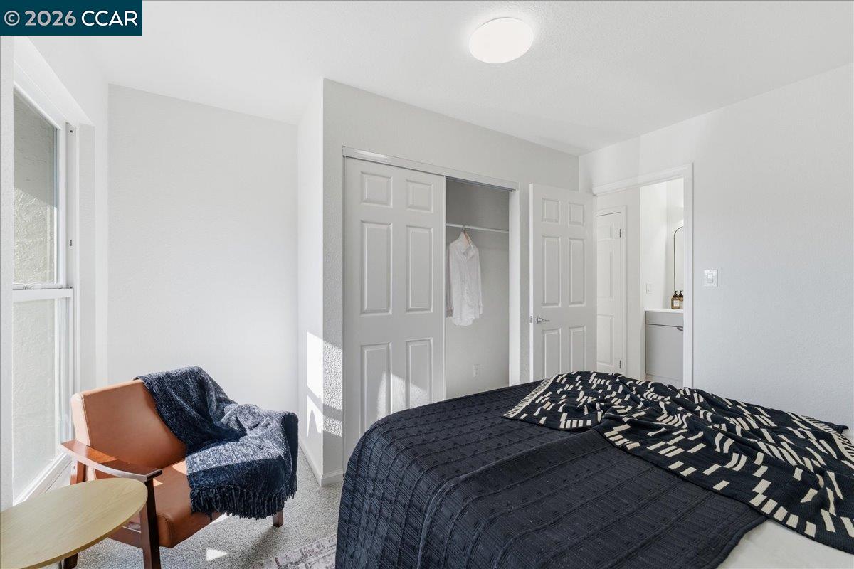 4740 Appian Way, Unit 9 El Sobrante, CA 94803 - Photo 15 of 23 a bedroom with a bed and chair