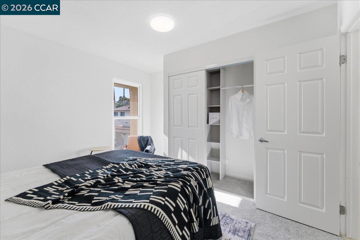 4740 Appian Way, Unit 9 El Sobrante, CA 94803 - Photo 16 of 23 a bedroom with a bed and a window