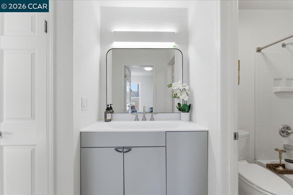 4740 Appian Way, Unit 9 El Sobrante, CA 94803 - Photo 18 of 23 a bathroom with a sink vanity and a mirror