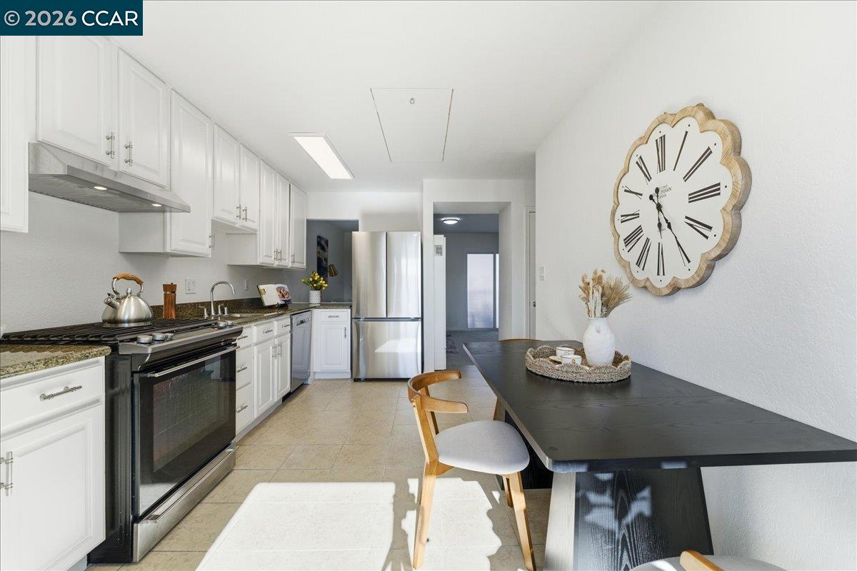 4740 Appian Way, Unit 9 El Sobrante, CA 94803 - Photo 9 of 23 a kitchen with stainless steel appliances granite countertop a sink a stove top oven a counter space and cabinets