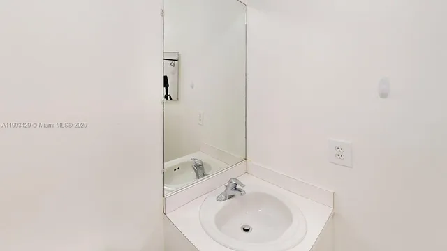 a bathroom with a sink and mirror