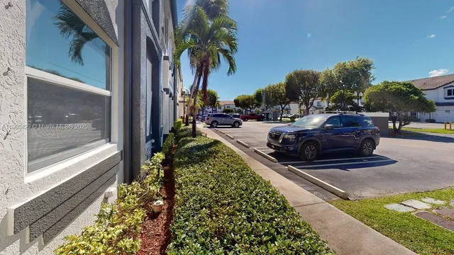 a view of a backyard with plants and a patio