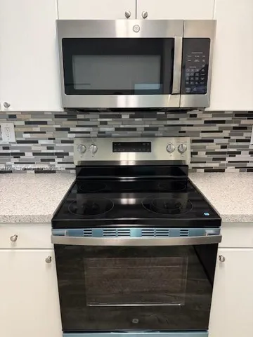 a stove top oven sitting inside of a kitchen