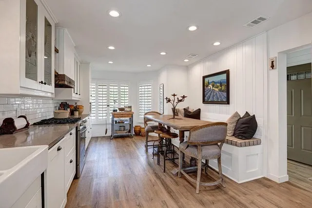 a kitchen with white cabinets and white appliances