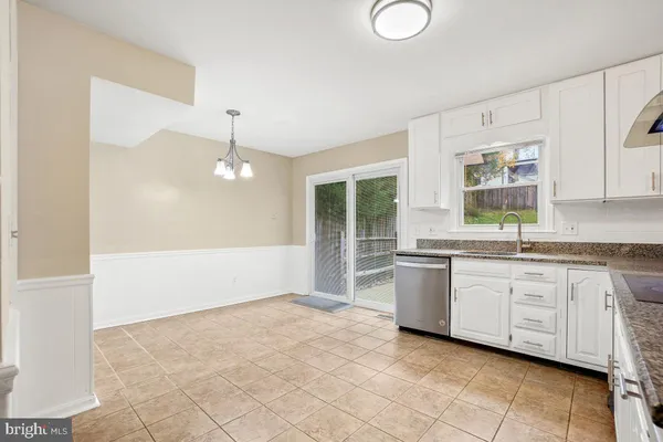 a large white kitchen with a window