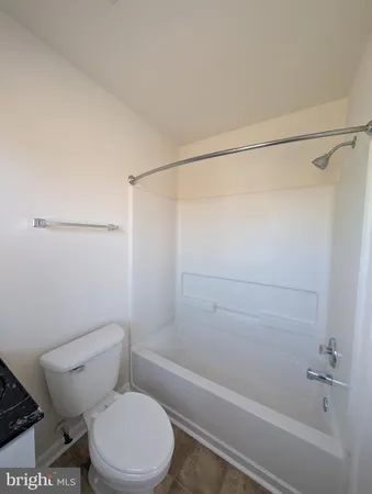 a bathroom with a toilet a sink and a window