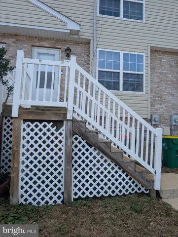 a view of a brick house with wooden fence