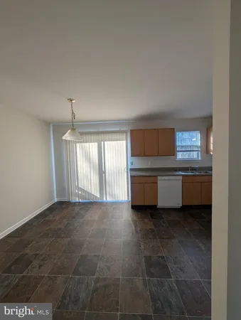 a kitchen with a sink a stove and cabinets