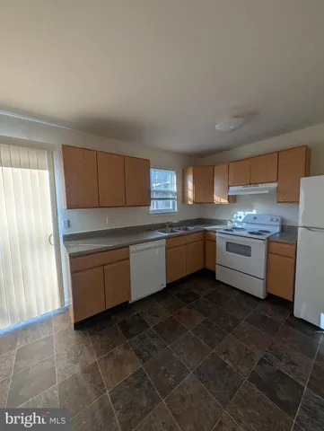a kitchen with a stove a sink and a refrigerator