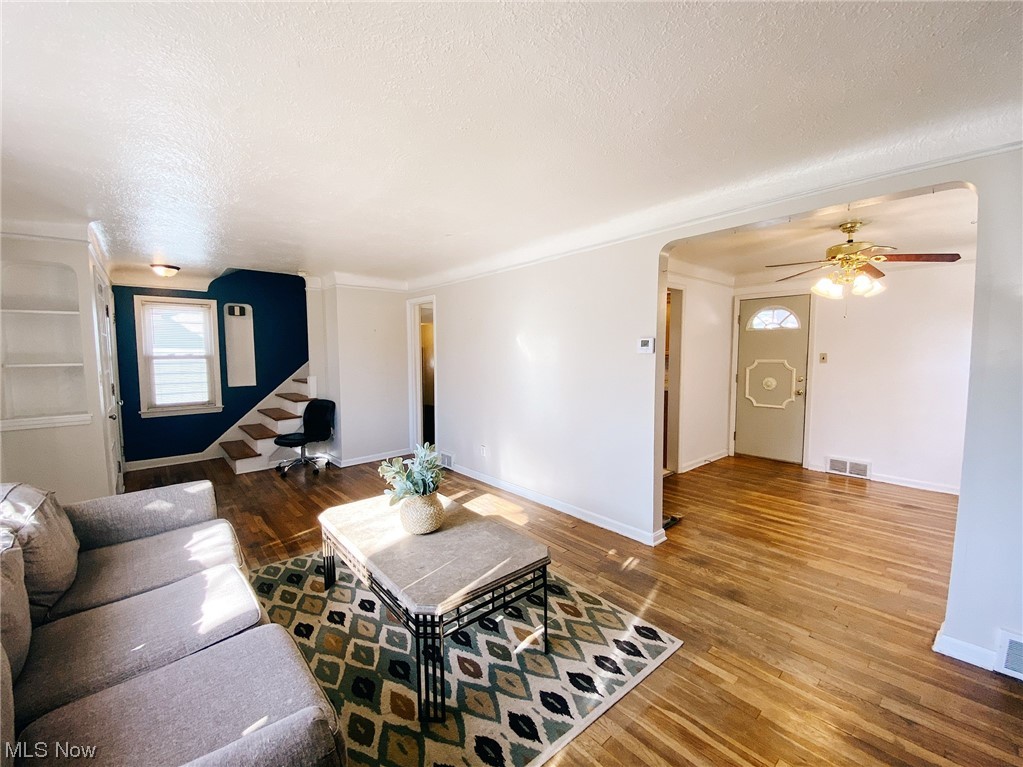 9704 Snow Road Cleveland, OH 44130 - Photo 7 of 24 Living room featuring ceiling fan, a textured ceiling, and hardwood / wood-style flooring