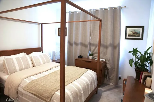a bed sitting in a bedroom next to a window