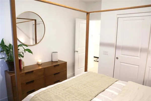 a bedroom with a bed and a mirror