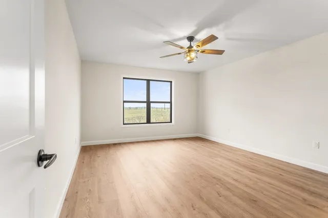 a view of an empty room and wooden floor