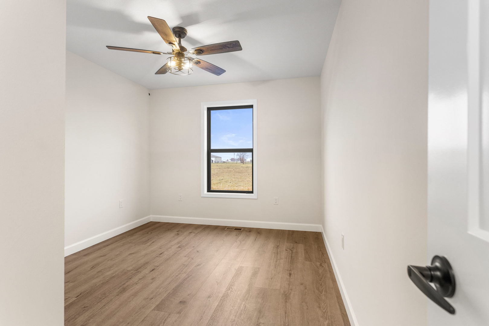 513 Patterson Drive Fisher, IL 61843 - Photo 19 of 25 an empty room with a window and a ceiling fan