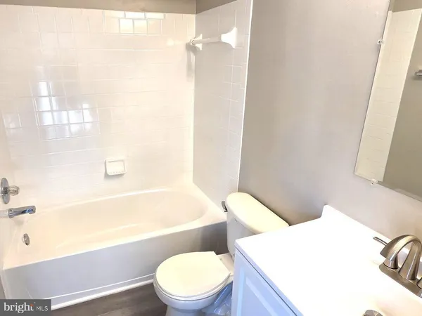 a bathroom with a sink a toilet and bathtub