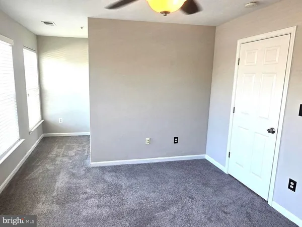 an empty room with windows and entrance