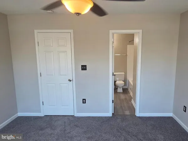 a bathroom with a toilet and a bathtub