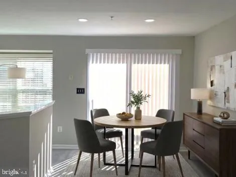 a view of a dining room with furniture and window
