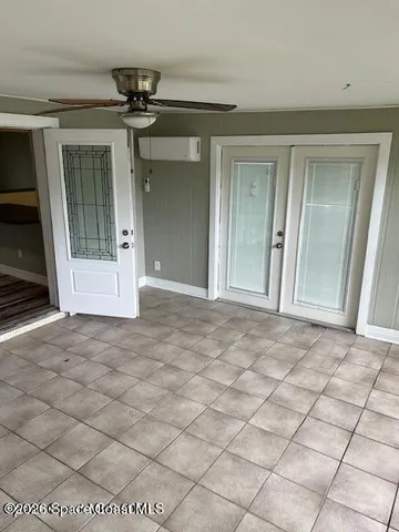 a view of a hallway with wooden floor and chandelier