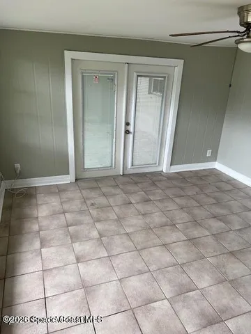 a view of a livingroom with an empty space and a window