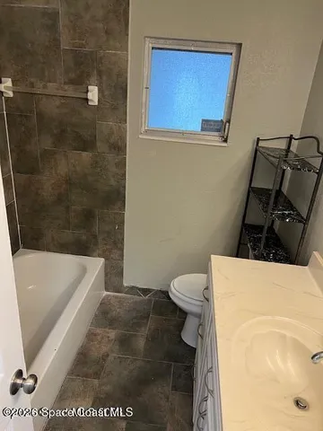 a bathroom with a bathtub and a toilet