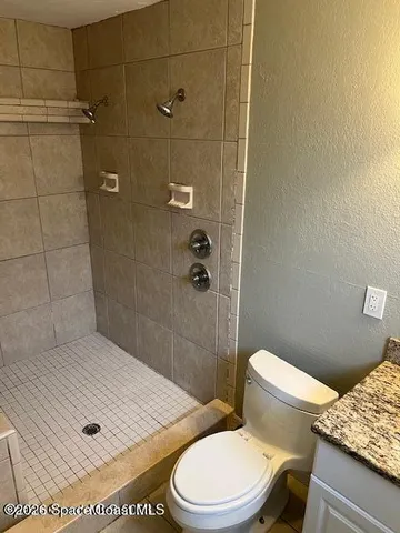 a view of a house with a yard and potted plants