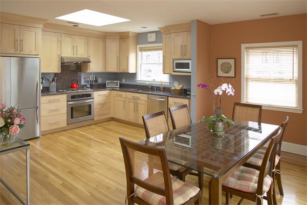 28 Surrey Street, Unit 3 Cambridge, MA 02138 - Photo 1 of 6 a kitchen with a table chairs refrigerator and microwave