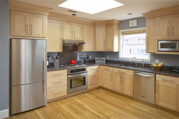 28 Surrey Street, Unit 3 Cambridge, MA 02138 - Photo 2 of 6 a kitchen with stainless steel appliances granite countertop a refrigerator sink and stove