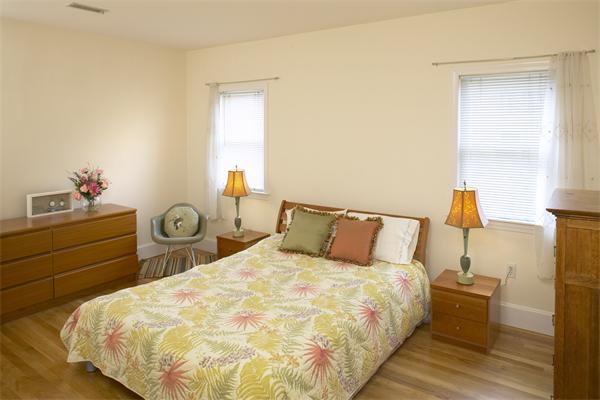 28 Surrey Street, Unit 3 Cambridge, MA 02138 - Photo 4 of 6 a bed sitting in a bedroom next to a window with dresser