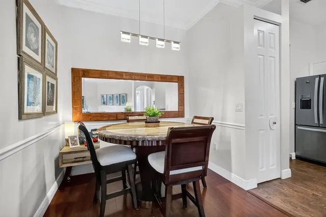 a dining room with furniture a chandelier and wooden floor