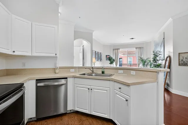 a kitchen with white cabinets and a sink