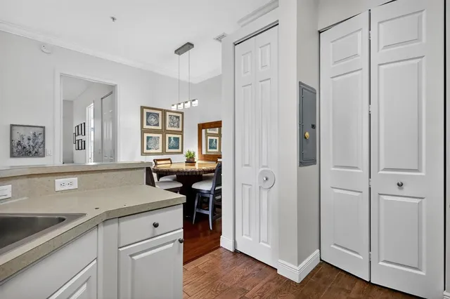 a view of a kitchen counter space with wooden floor and cabinets