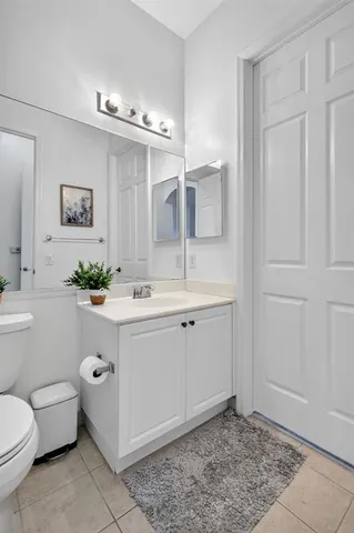 a spacious bathroom with a toilet sink and mirror