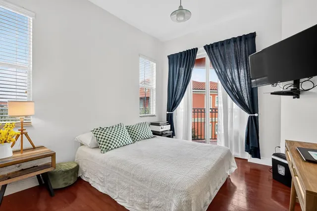 a bedroom with a bed and a large window