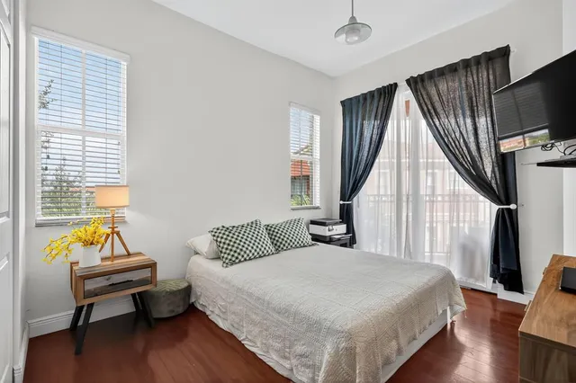 a bedroom with a bed and wooden floor