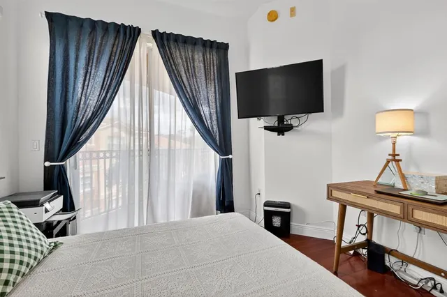 a view of a livingroom with furniture and a flat screen tv