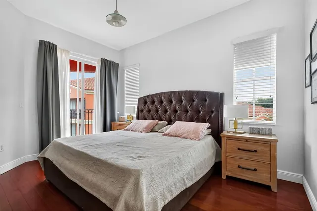 a bedroom with a large bed and a window