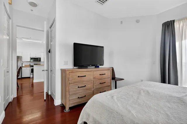 a bedroom with a bed and flat screen tv