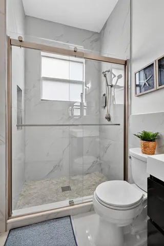 a bathroom with a toilet a sink and shower