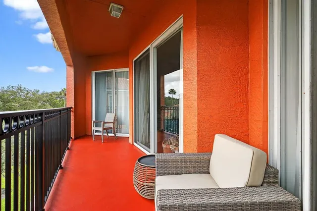 a balcony with furniture and a potted plant