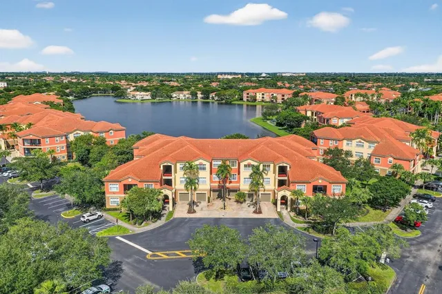 an aerial view of residential houses with outdoor space and river