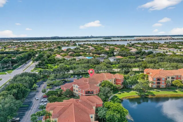 an aerial view of residential houses with outdoor space and lake view