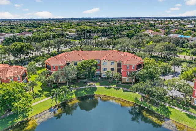 an aerial view of a house with swimming pool outdoor seating and yard