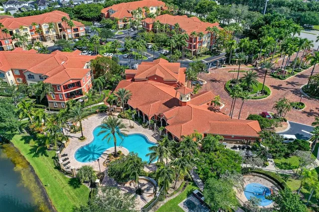 an aerial view of a house with a garden and swimming pool