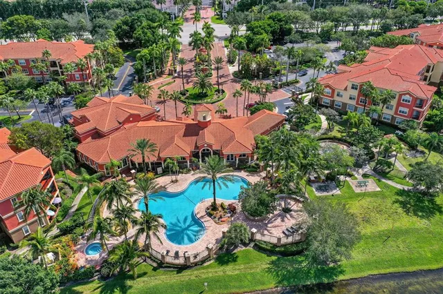 an aerial view of residential houses with outdoor space and trees