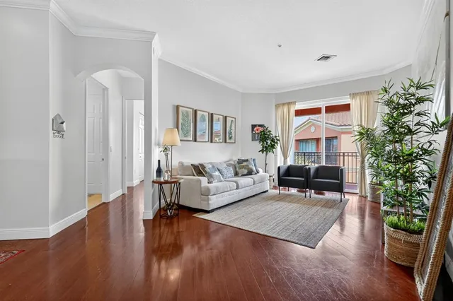 a living room with furniture and a potted plant