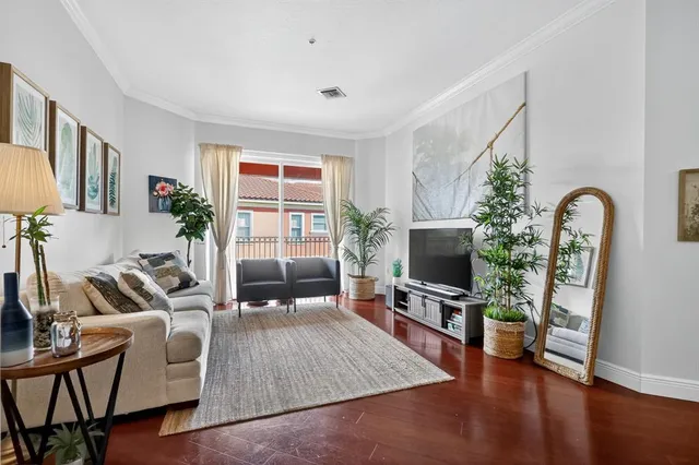 a living room with furniture a flat screen tv and a large window